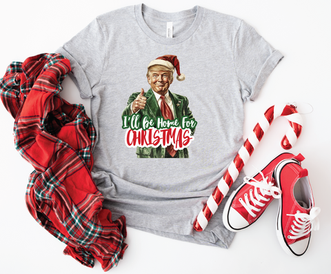 Trump "I'll Be Home for Christmas" softstyle shirt featuring a humorous design, perfect for celebrating the holiday season with a playful touch.